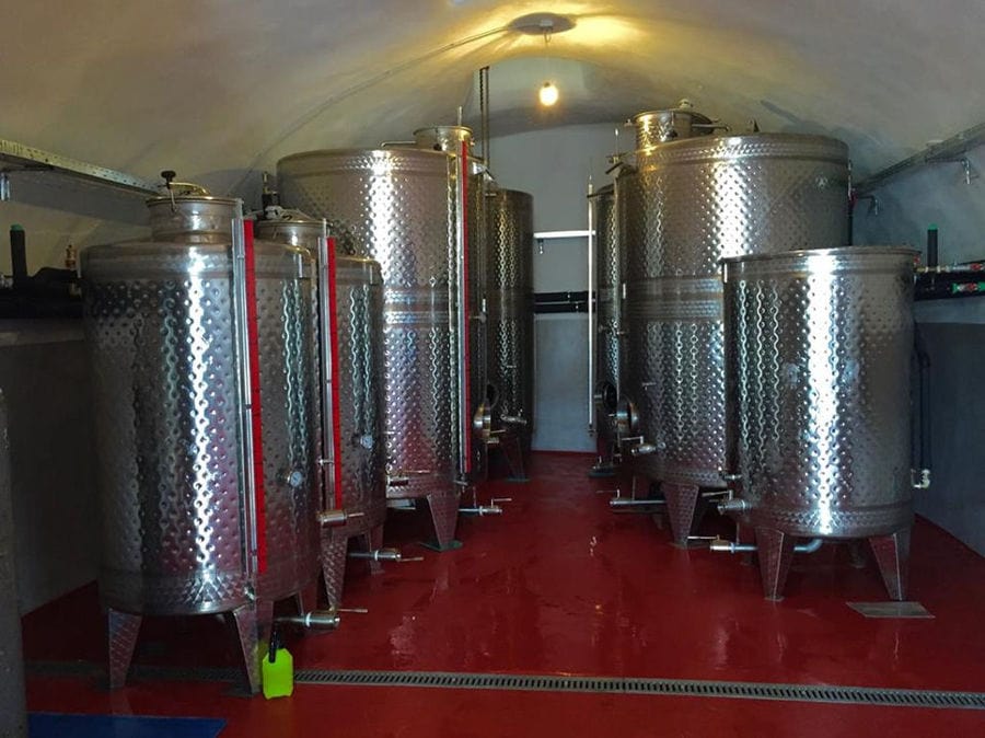 lying aluminum wine storage tanks at Tselepos Winery plant